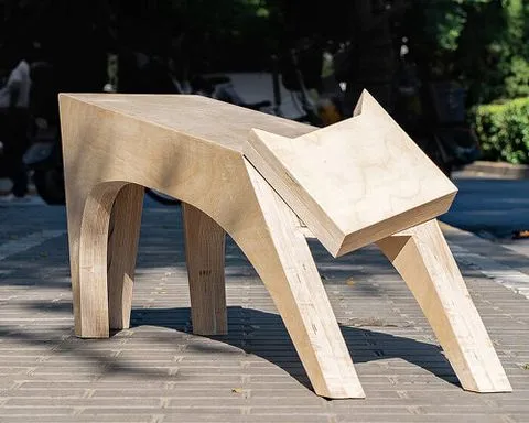 traditional potter’s stand becomes a timber bench shaped like a stretching cat